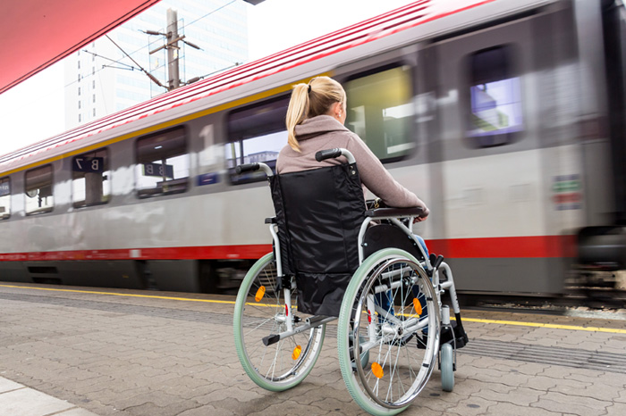 girl in wheelchair on train platform