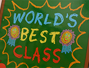 "World's Best Class" written on a chalkboard.