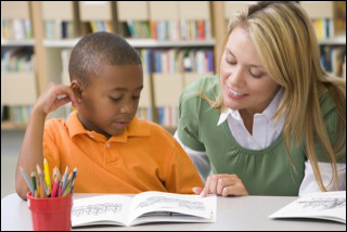 bigstock_Student_In_Class_Reading_With__3917499