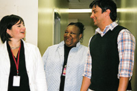 two nurses and a teacher talking in the hallway