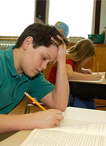 Student writing in a workbook