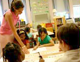 Teacher helping students at their desks