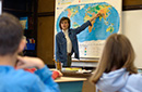 teacher pointing an area on a map