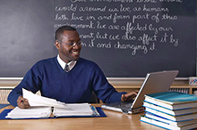 Teacher reading at his desk