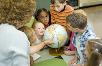 Teacher pointing at a globe