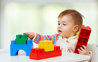 toddler with cube toys