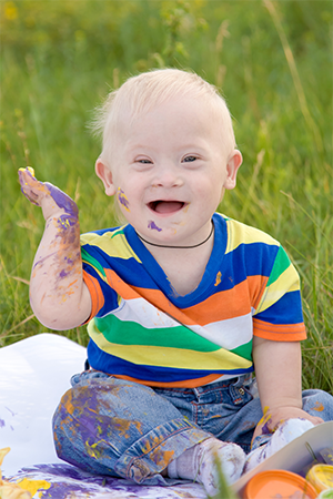 toddler playing with paint outside