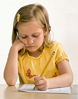 young girl writing quietly