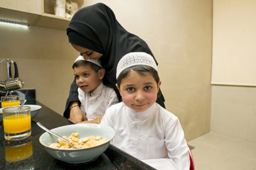 young boys in the kitchen with their mother