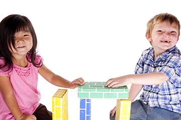 boy and girls with play blocks