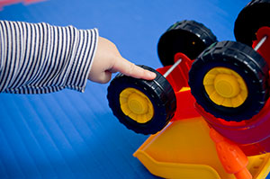 spinning the wheels on a toy truck