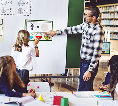 Teacher at board with student