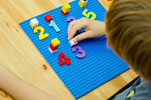 boy with manipulative number board