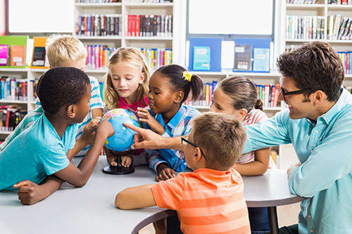 Teacher and students with globe