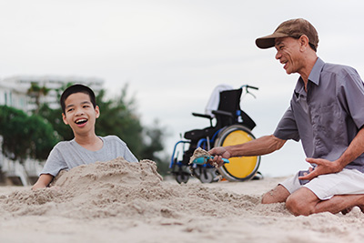 father and disabled so playing on beach