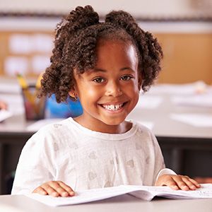 Girl smiling with workbook