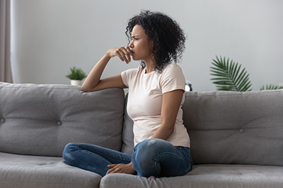 teen sadly thinking on sofa