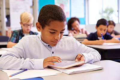 boy working on iPad at desk