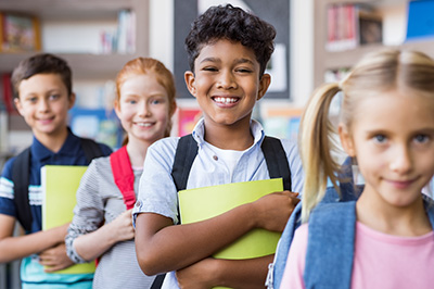 boy walking in line and smiling