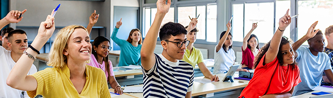 Pupils raising their hands during class 